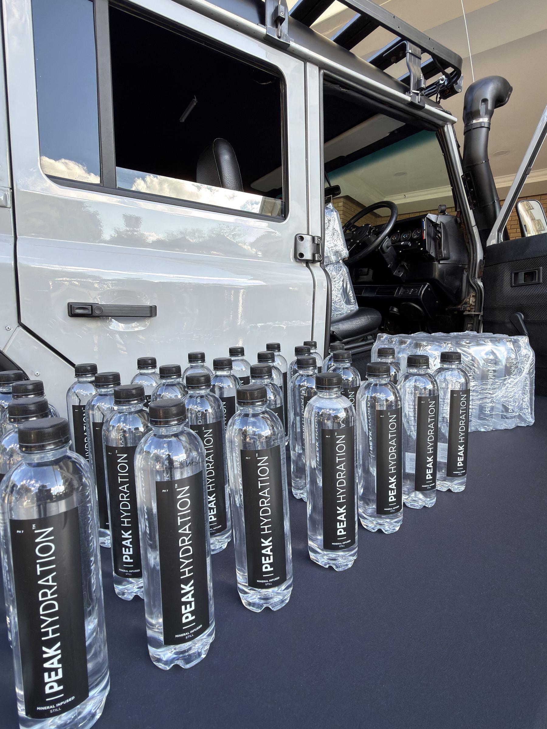 Rows of Peak Hydration bottles ready for an event