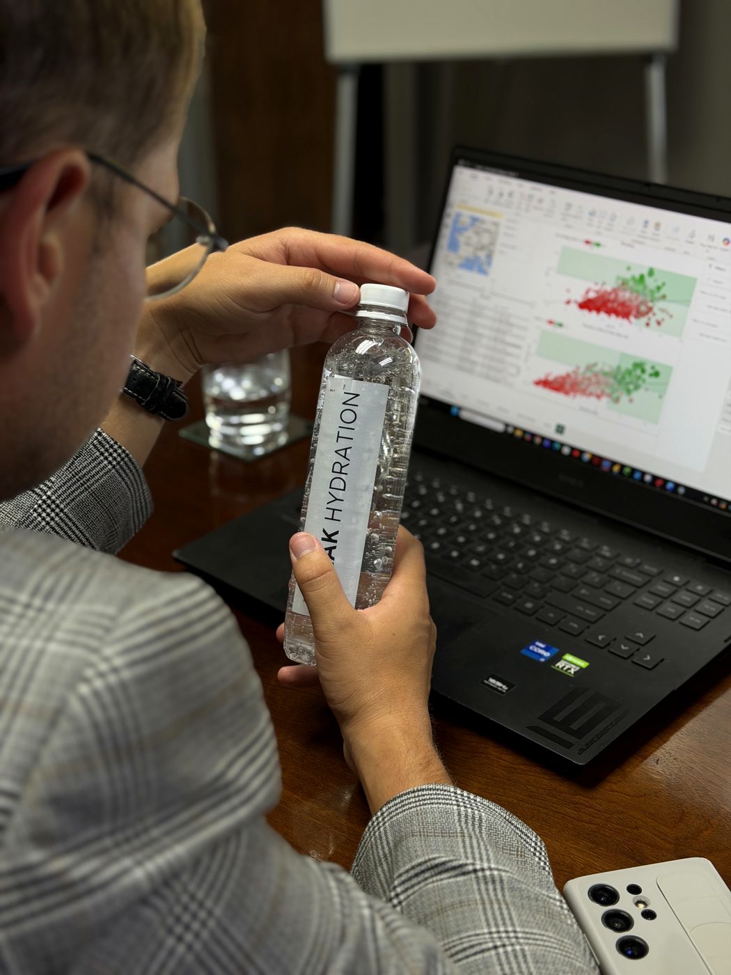Peak Hydration in hand at a desk, mid-way through a long working day