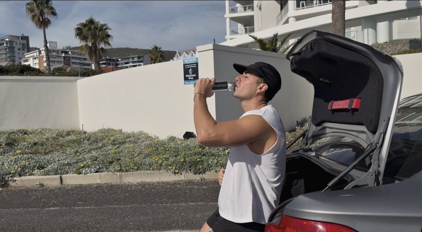 A drink by the car after an early run on the coast